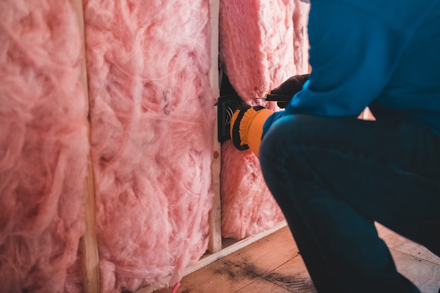 tradesperson working with loft insulation